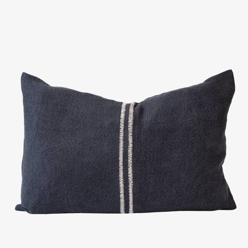 Dark navy pillow with a white stripe on a light gray background