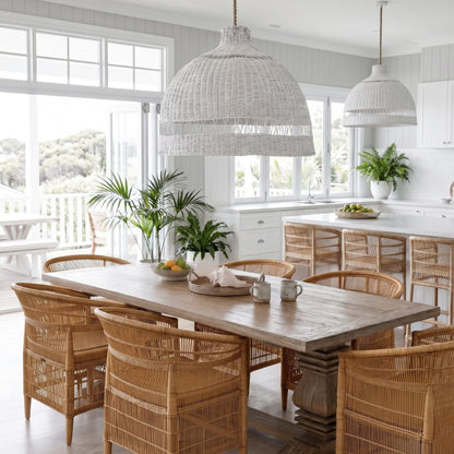 Dining area with wooden table and chairs, white pendant lights, and large windows.