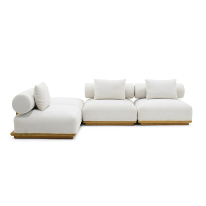 A modern modular sectional sofa with off-white cushions and light natural wood bases, shown on a plain white studio background.