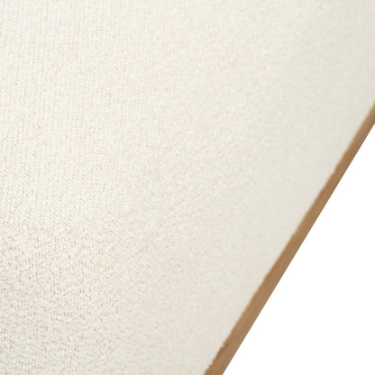 A close-up of a textured off-white fabric or material surface with a tan edge visible against a white background.