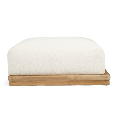 A modern low-profile ottoman or bench with a thick, square, off-white textured cushion on a solid light natural wood base, shown against a plain white background.