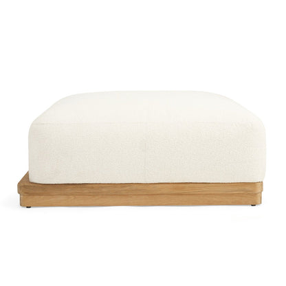 A square ottoman with a cream-colored bouclé fabric top and a natural oak wood base, shown from a front-facing perspective on a solid white background.
