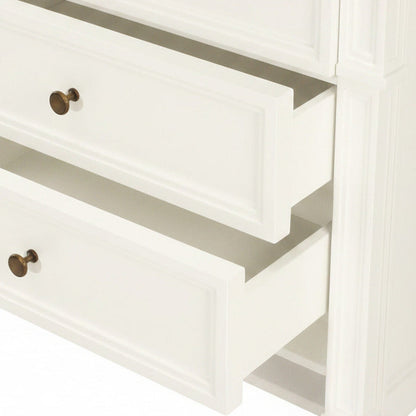 Close-up of a white wooden cabinet with a brass handle.