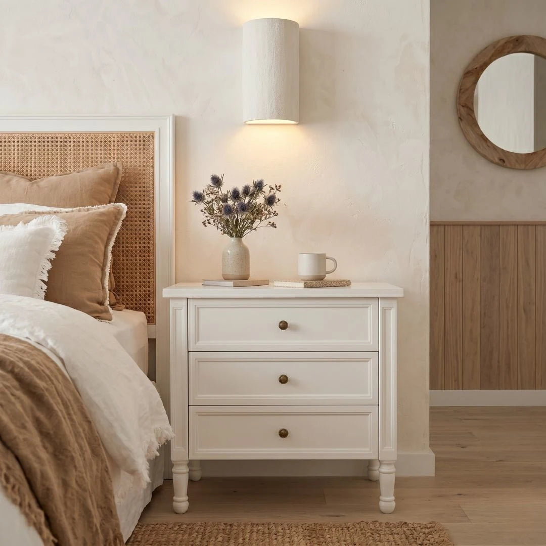 Bedroom with a bed, nightstand, lamp, and decorative elements.