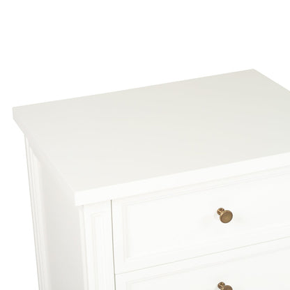 White rectangular object with a gold button on a white background