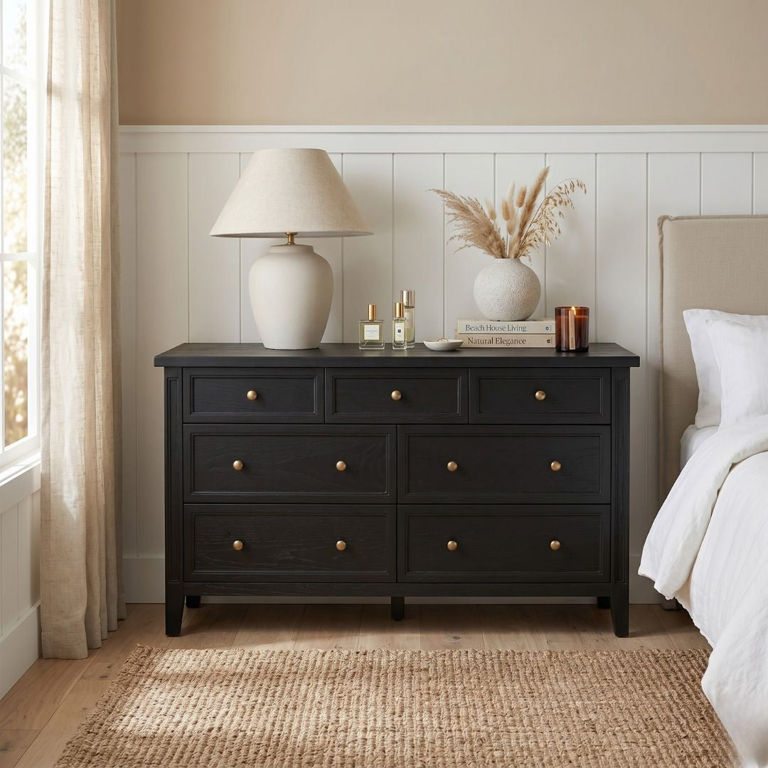 Black dresser with decorative items in a bedroom setting