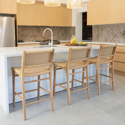 Modern kitchen with white island, stools, and wooden cabinets.