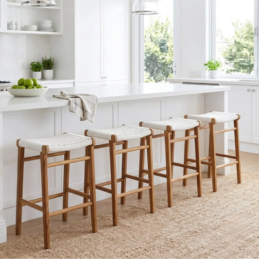 Four wooden bar stools with white seats in a kitchen setting.