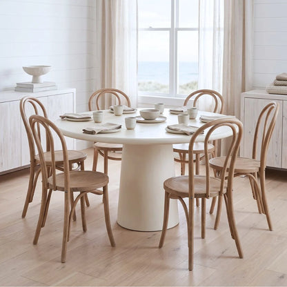European Café Chair in Weathered Oak around the Elio white microcement dining table in a styled dining room by Sun Republic
