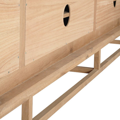 Close-up of a light natural wood cabinet or sideboard with visible grain, panel seams, circular cutouts, and a matching wooden support frame, shown against a plain white background.