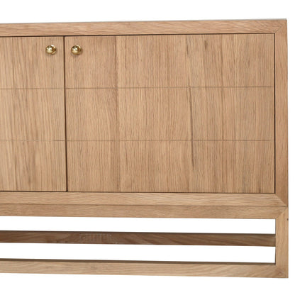 A close-up of a light oak wood cabinet with two doors, featuring a grid pattern of recessed panels and small round brass knobs, set against a plain white background.