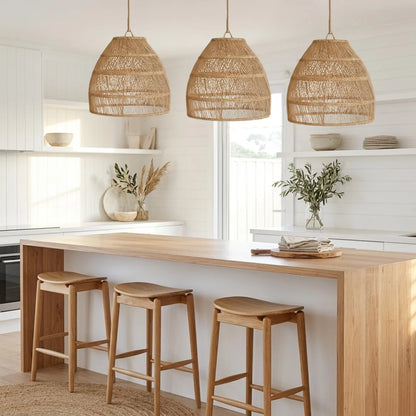 Modern kitchen with wooden island, stools, and wicker pendant lights.