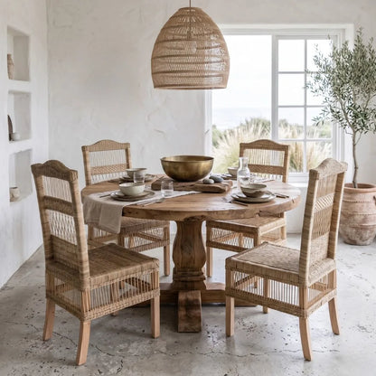 Dining room with wooden table and chairs, gold bowl, and decorative elements.
