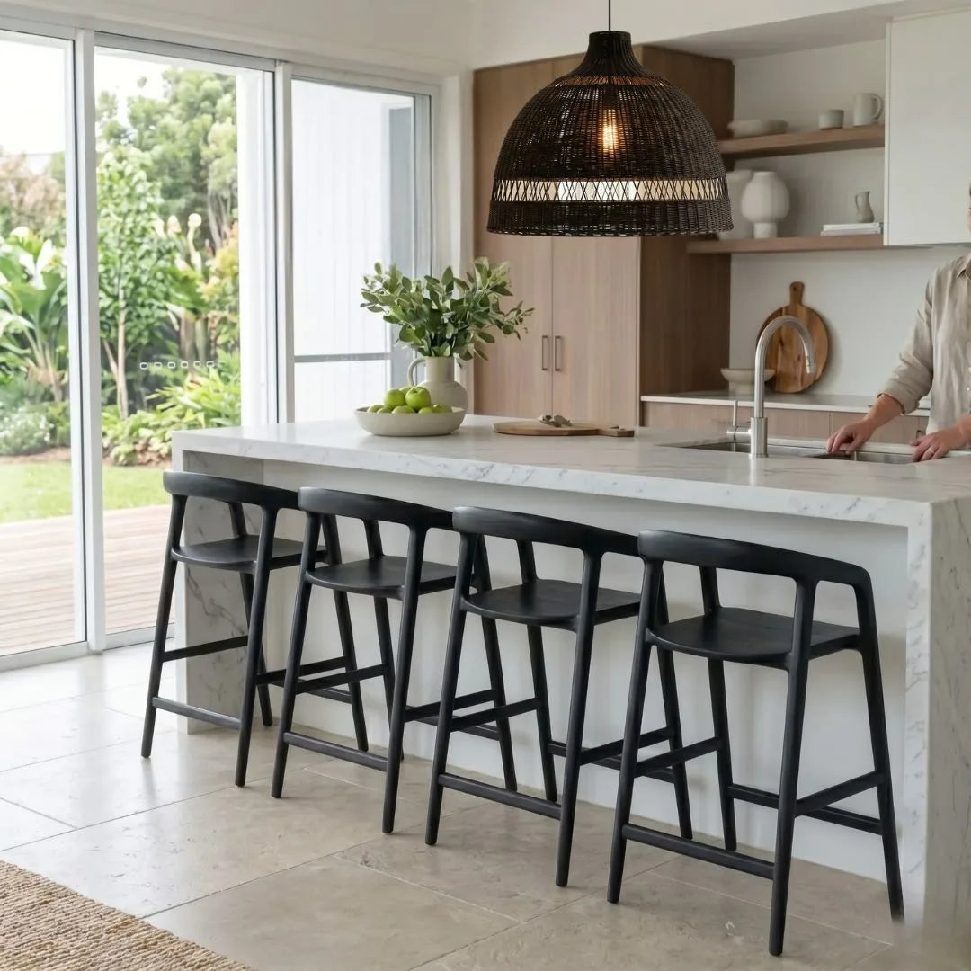 Modern kitchen with marble island and black bar stools