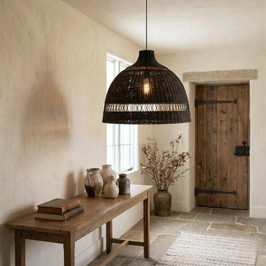 Rustic interior with a wooden bench, vase, and pendant light.