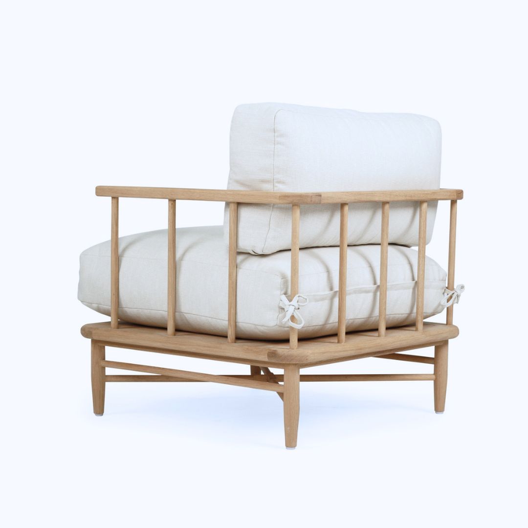 Wooden chair with white cushions on a white background