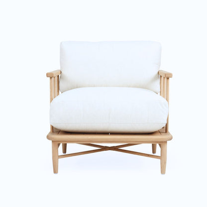White cushioned armchair with wooden frame on a white background