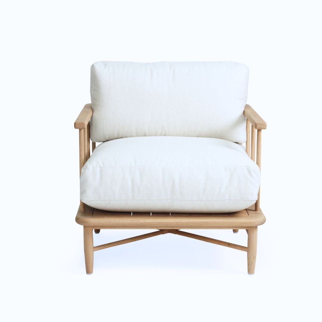 Wooden armchair with white cushions on a white background