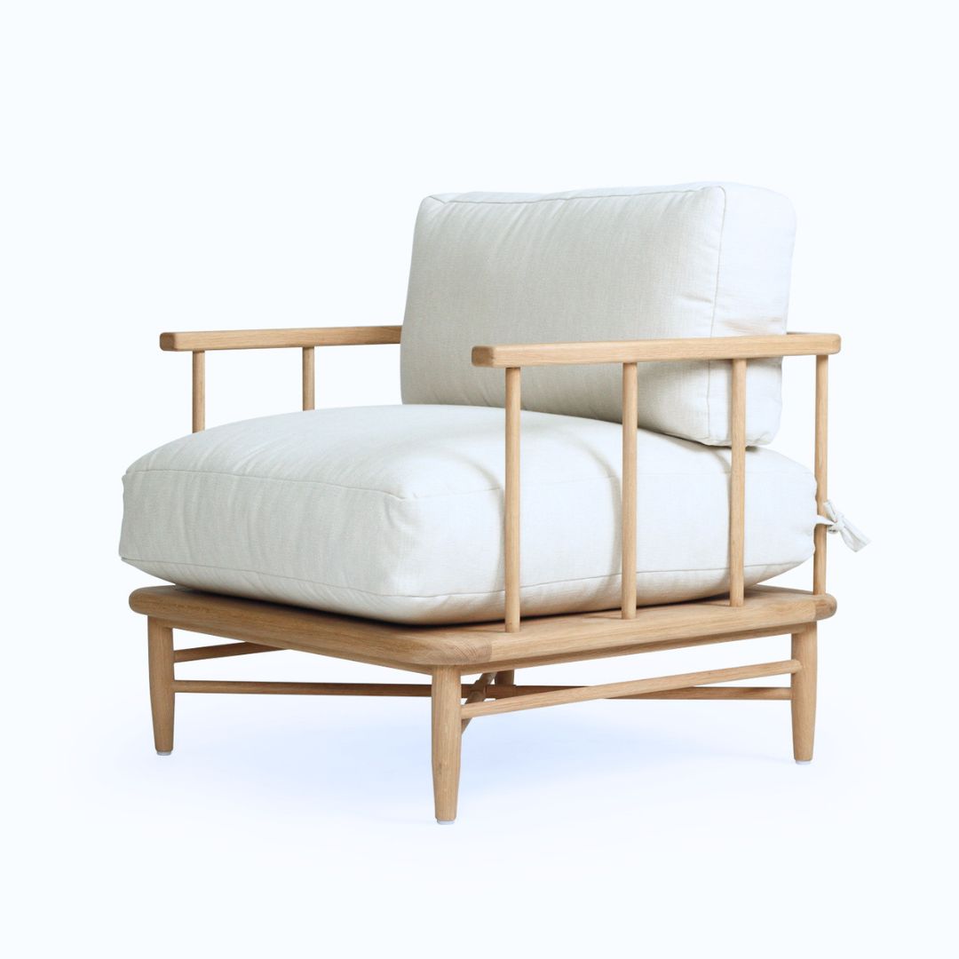 Wooden armchair with white cushions on a white background