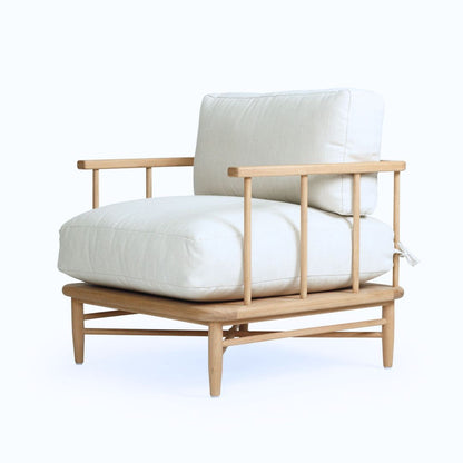 Wooden armchair with white cushions on a white background