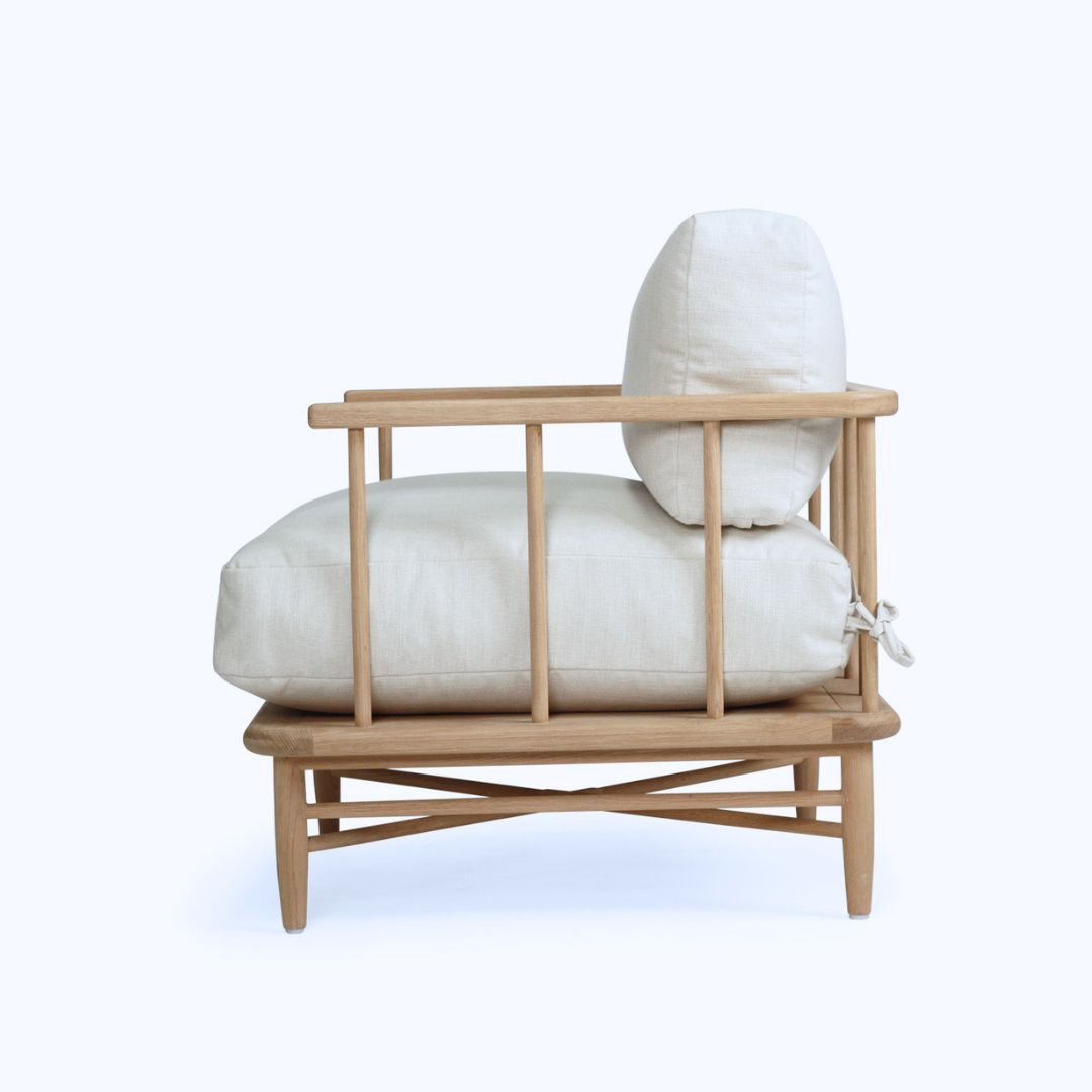 Wooden chair with white cushions on a white background