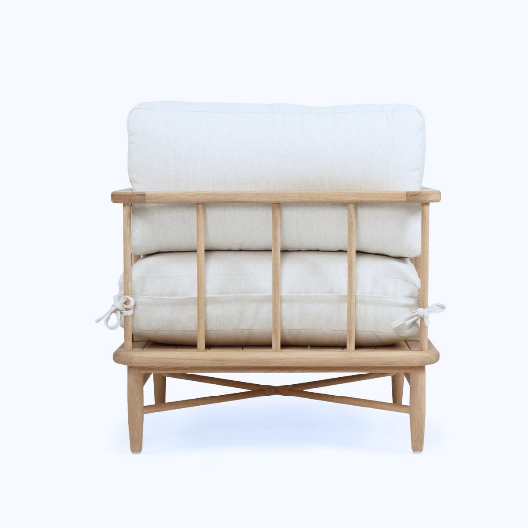 Stack of white pillows on a wooden stand against a white background