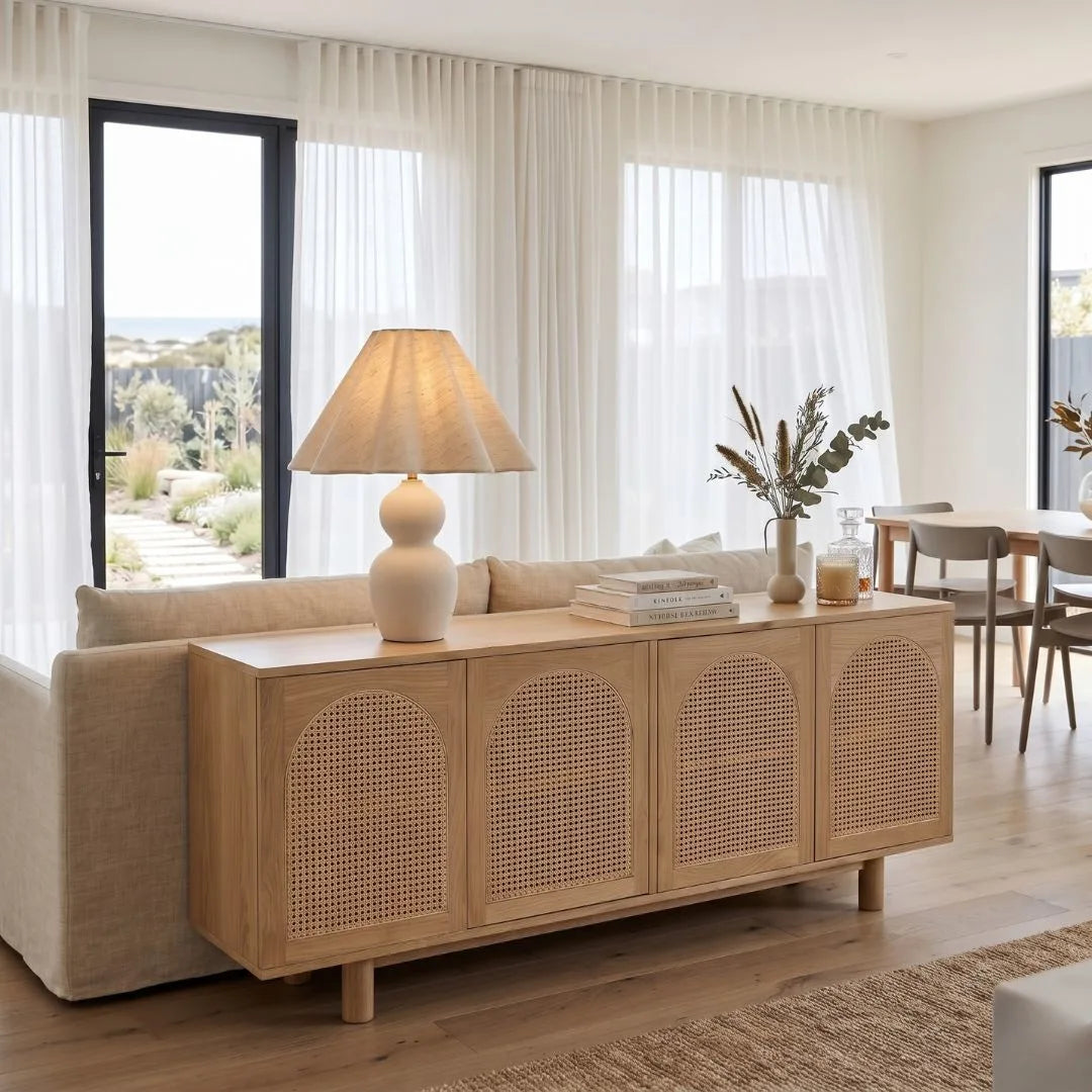 Living room with a wooden sideboard, lamp, and decor items.