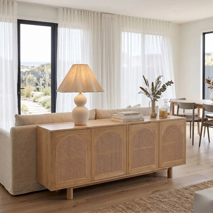 Living room with a wooden sideboard, lamp, and decor items.