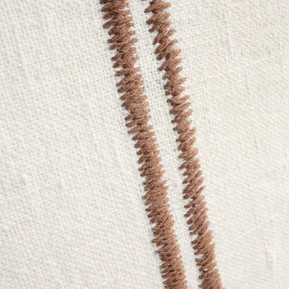 Close-up of brown textured lines on a white fabric background