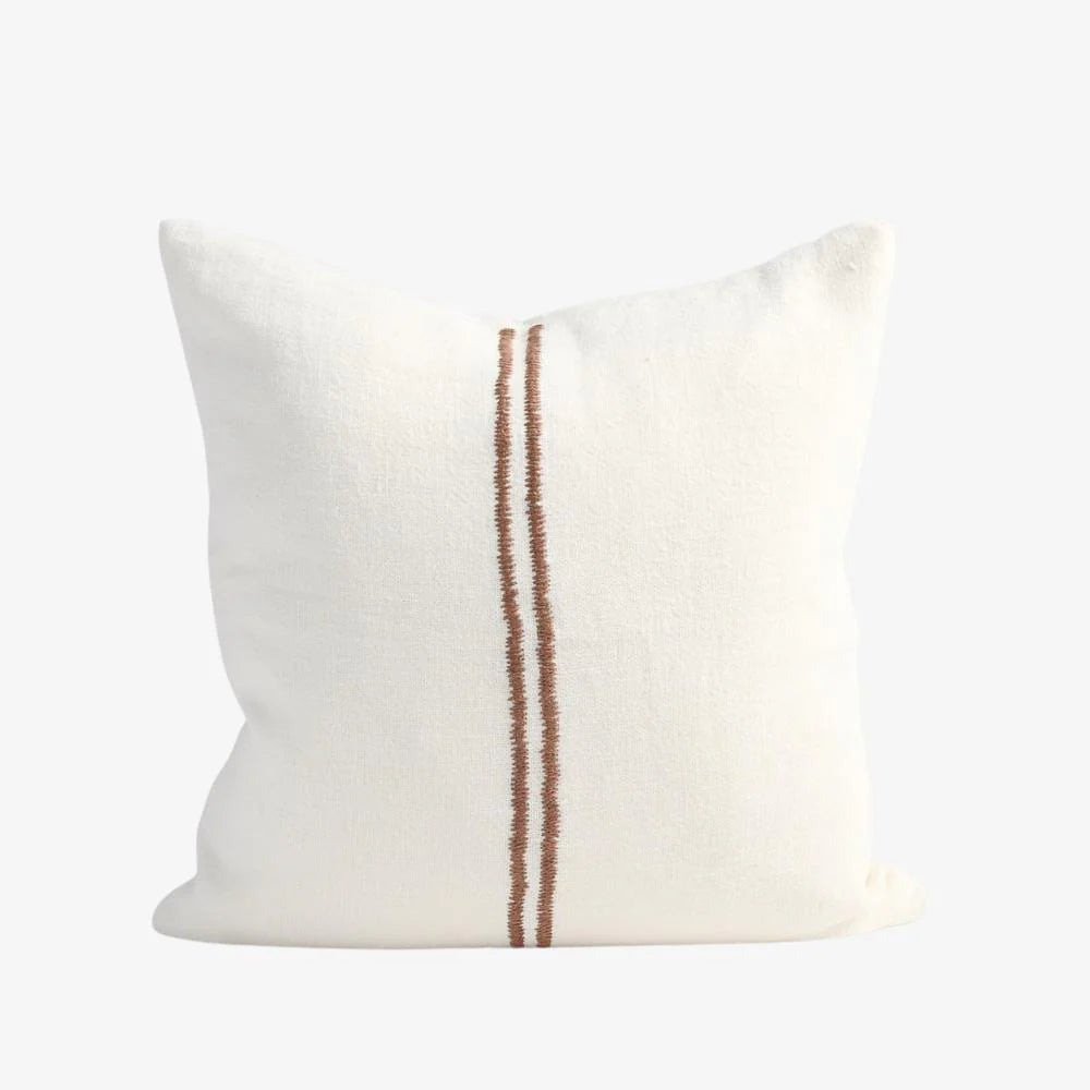 White pillow with a brown stripe on a white background