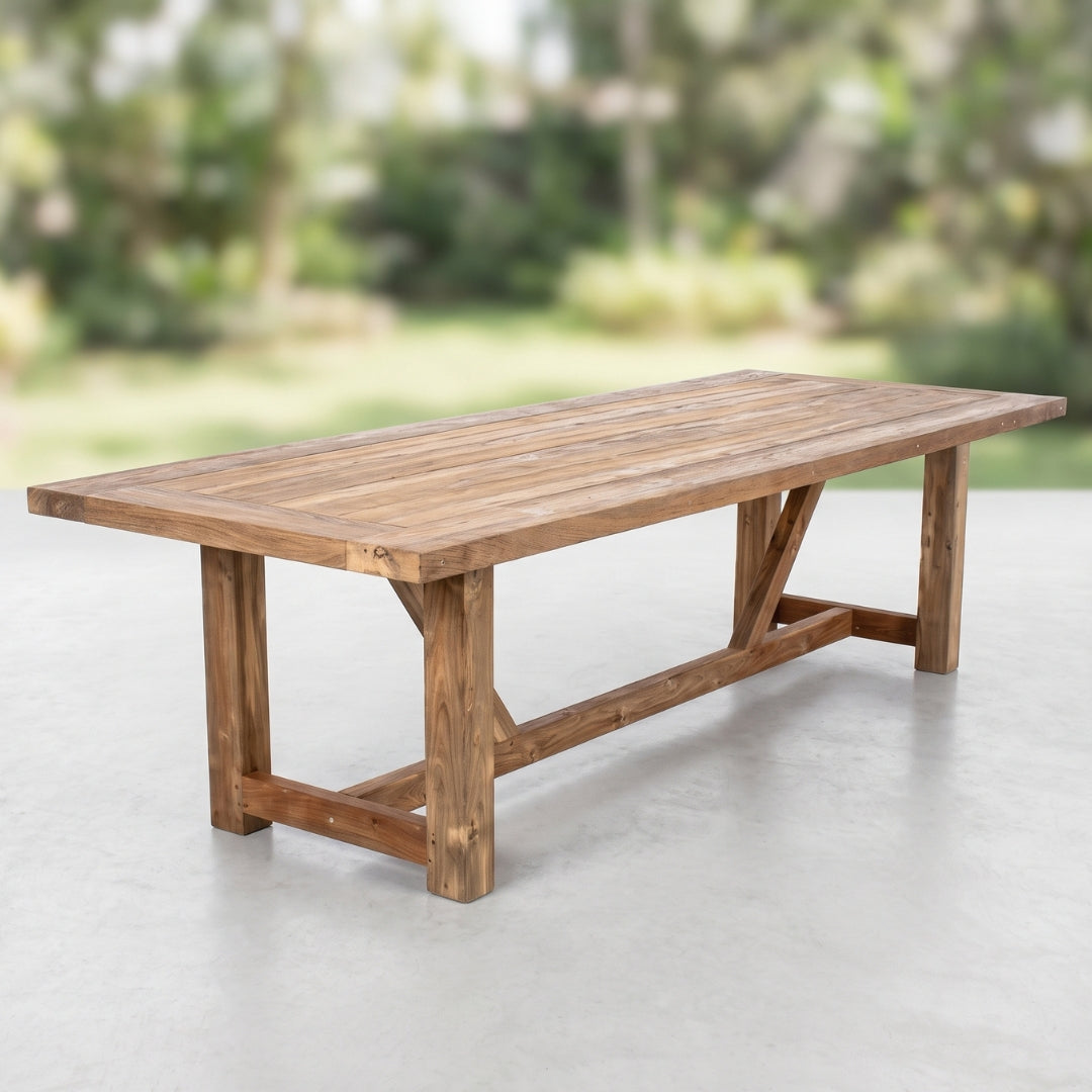 A rustic rectangular wooden dining table with a slatted top and crossed style leg supports,