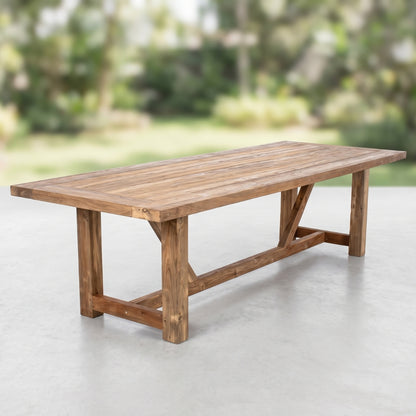 A rustic rectangular wooden dining table with a slatted top and crossed style leg supports,