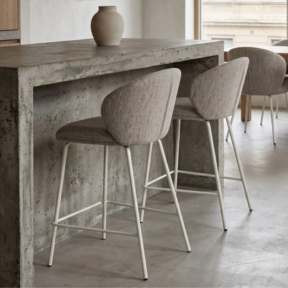 Concrete dining table with bar stools in a modern interior setting
