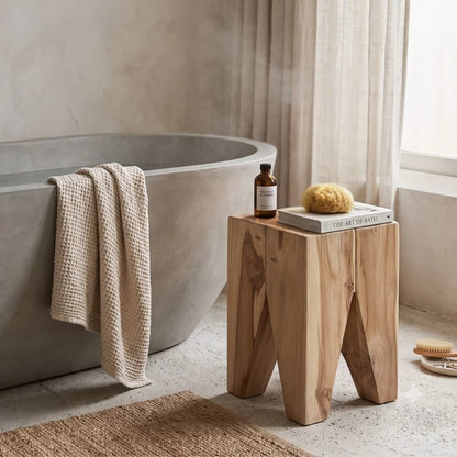 Square solid teak stump side table in a modern bathroom