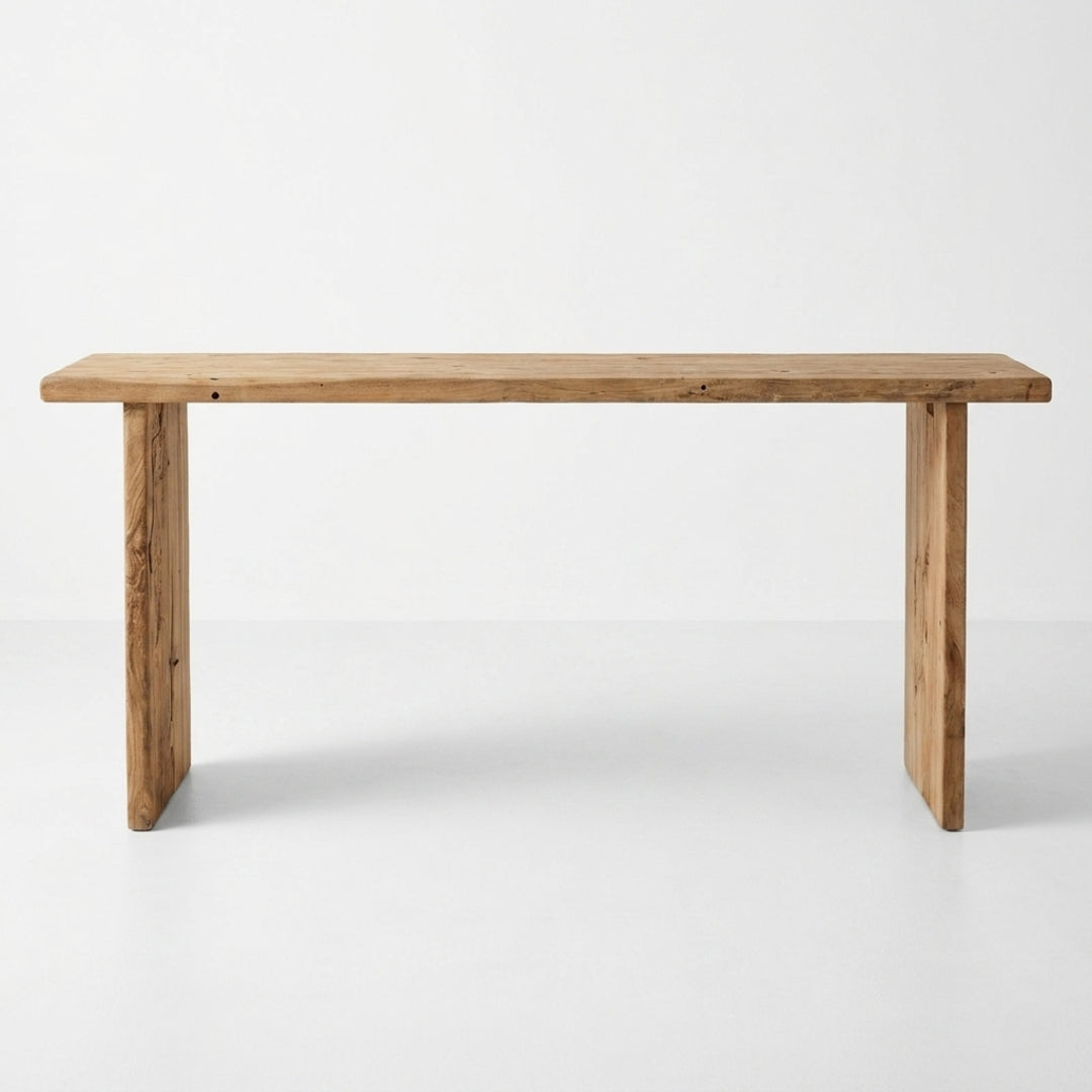 A rustic rectangular wooden table with thick block legs, shown from the front against a clean white studio background.