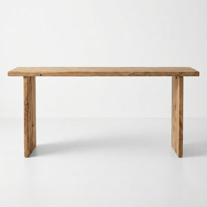 A rustic rectangular wooden table with thick block legs, shown from the front against a clean white studio background.