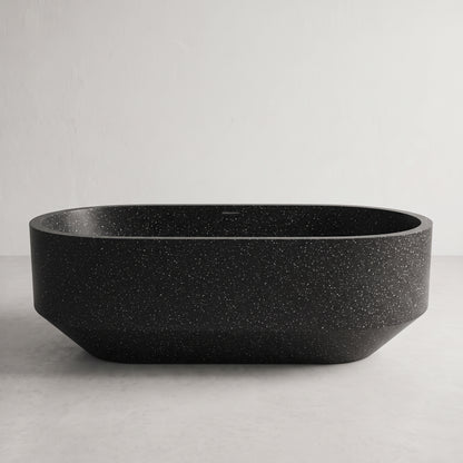A matte black freestanding bathtub with a subtle white speckled texture, shown against a neutral light gray background.