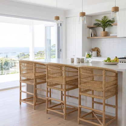 Modern kitchen with wicker bar stools and a white countertop.