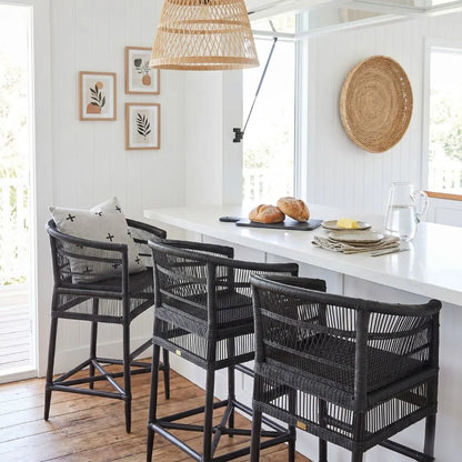 Dining area with black wicker chairs and a white countertop.