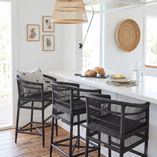 Dining area with black wicker chairs and a white countertop.