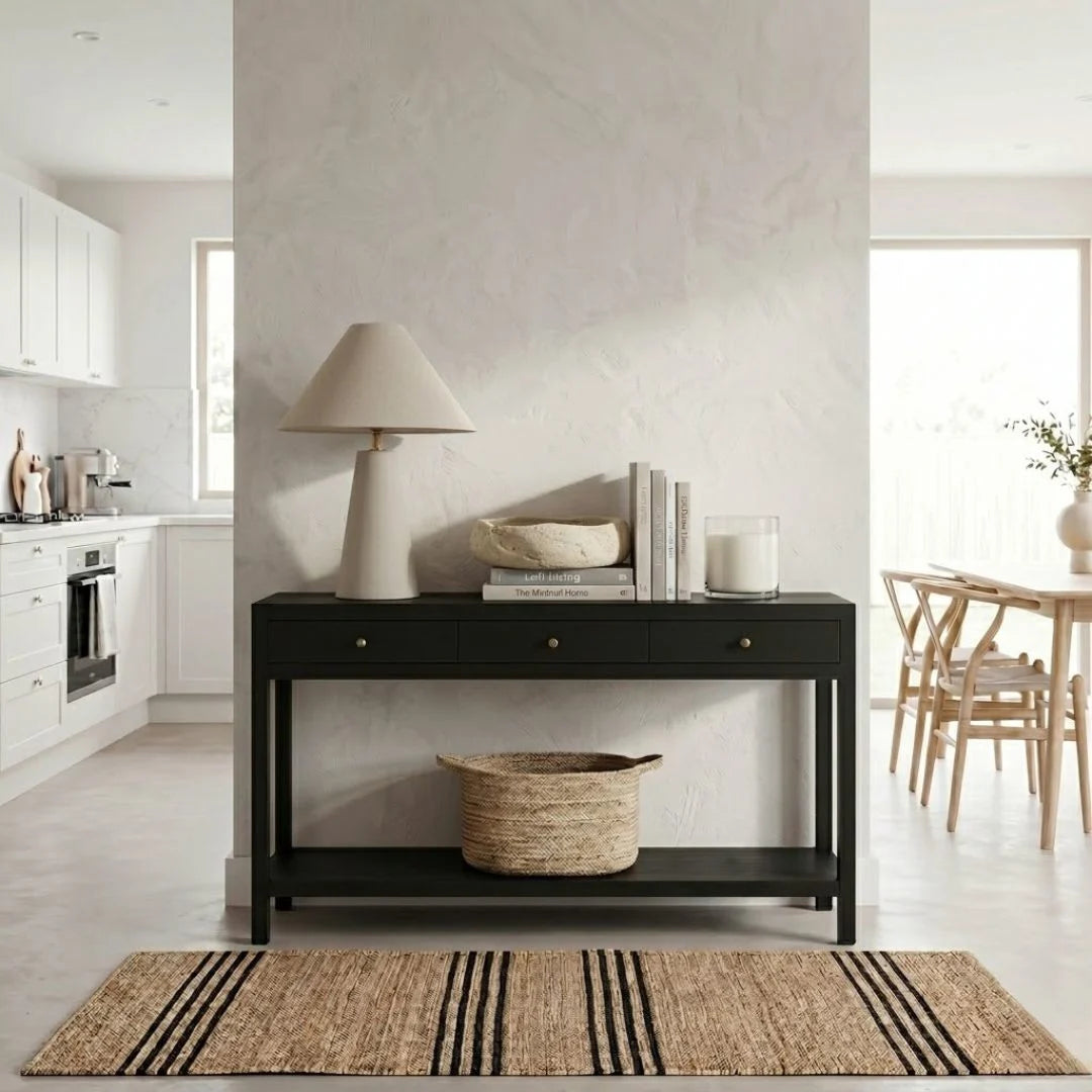 Black console table with decor items in a modern living room setting