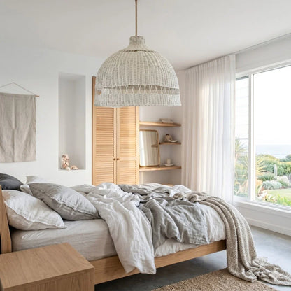 Modern bedroom with wooden bed, pendant light, and large window.