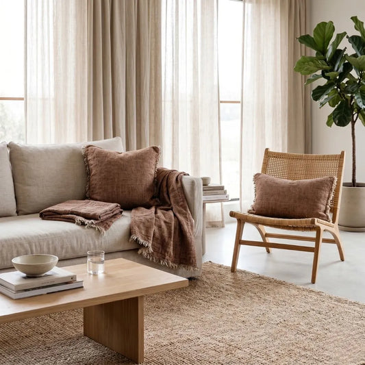 Cozy living room with beige sofa, wooden coffee table, and wicker chair.