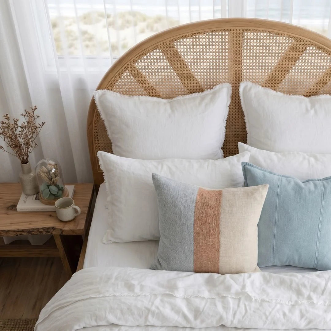 Sun Republic Tallow Cushion and bedding in a styled coastal bedroom