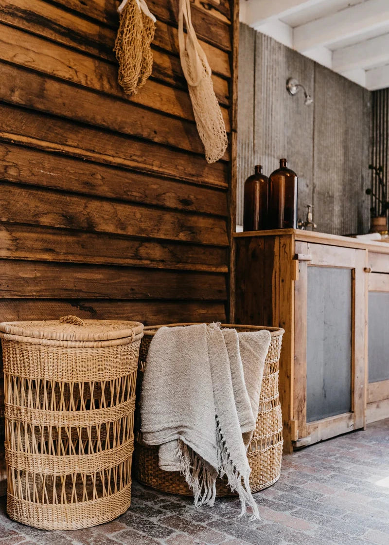 Rustic interior with wooden wall, wicker basket, and towel.