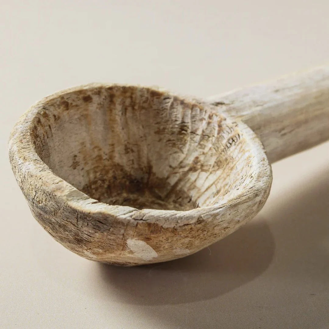 Wooden ladle on a beige background