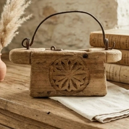 Wooden box with decorative carvings on a wooden surface