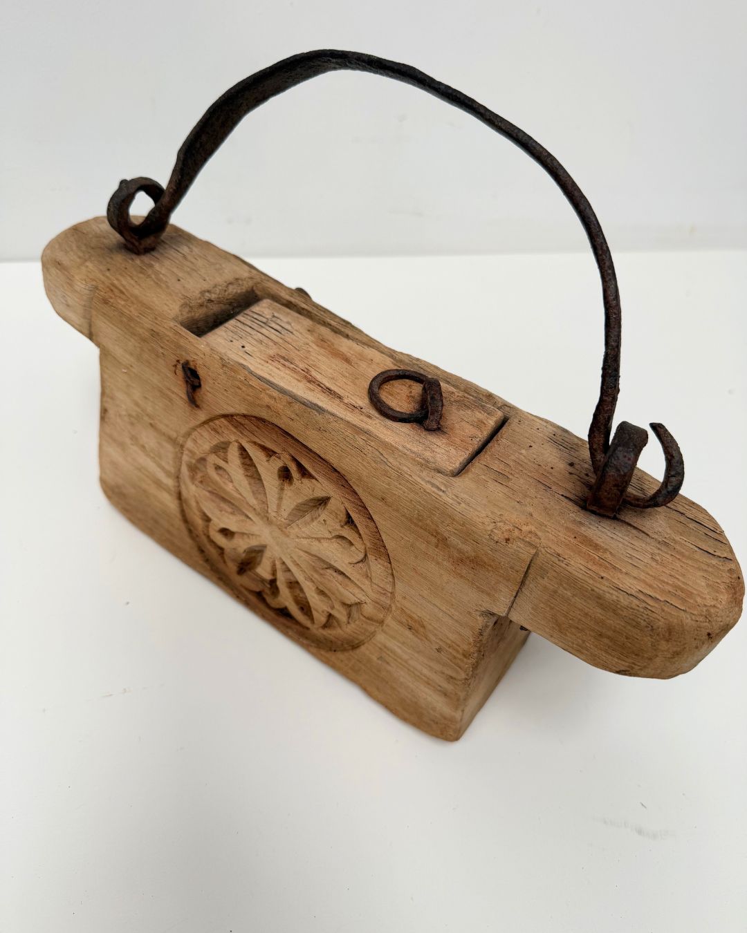 Vintage Indian Oil Pot with decorative carvings on a white 