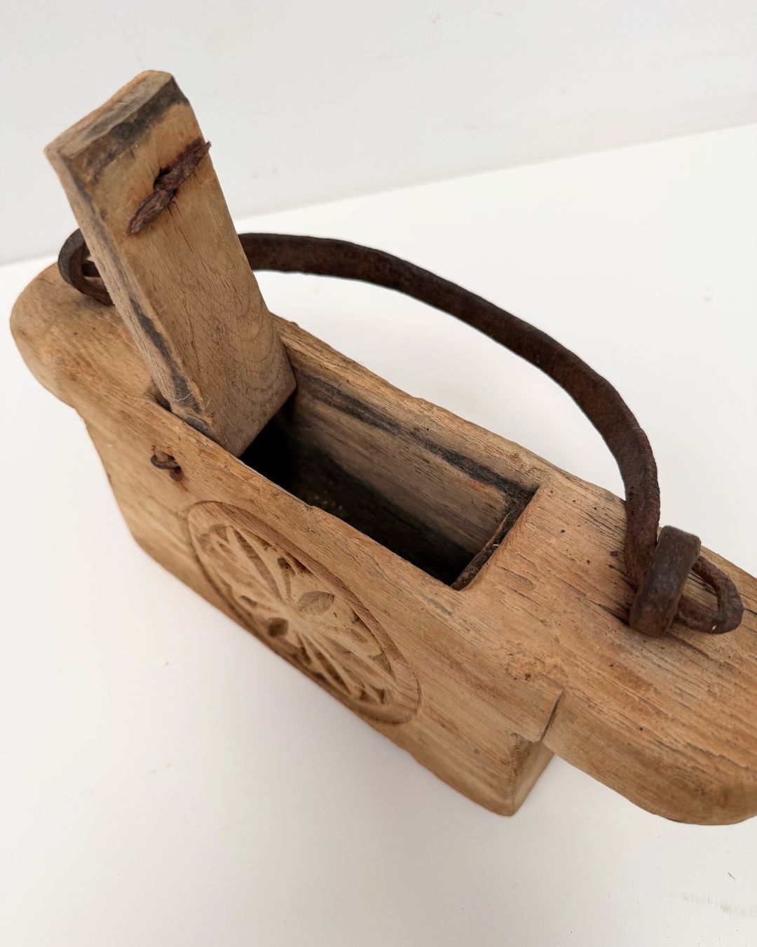 Vintage Indian Oil Pot with decorative carvings on a white 