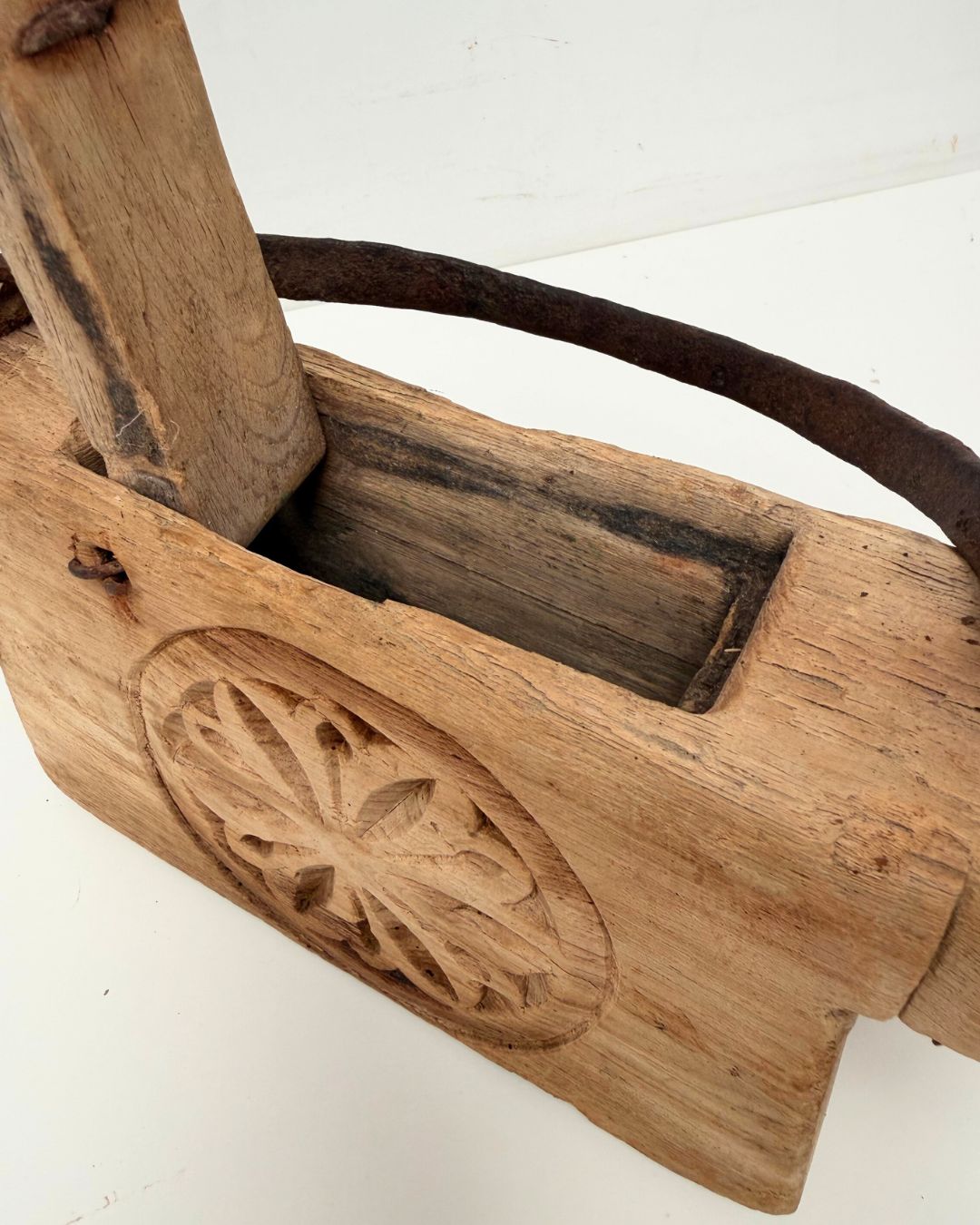 Vintage Indian Oil Pot with decorative carvings on a white 